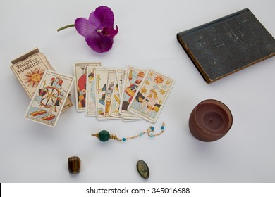 Tarot cards for a fortune -teller and pendulum isolated on white - Powered by Shutterstock