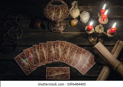 Tarot cards on fortune teller desk table background. Fortune reading concept. Magic mirror on paranormal table.