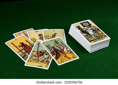 Tarot Cards Scattered On A Green Felt Table Top
