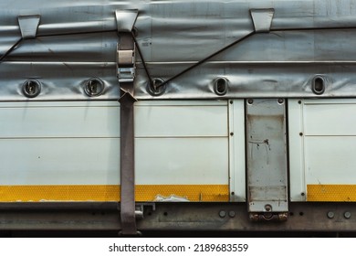 Tarpaulin On A Gray Truck. Protective Tarp On Car Trunk