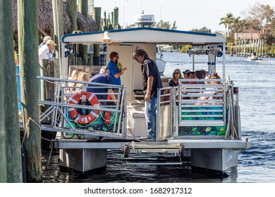 Tarpon Springs, Florida / USA - 1/18/2019:  Vacation Tourist On A Large Catamaran Pontoon Party Boat Sightseeing Birds, Alligators, And Fish, Not Fishing But Eating And Drinking Embarking The Dock