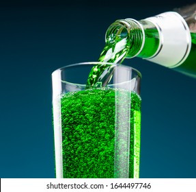 Tarragon Carbonated Drink Is Pouring From A Bottle Into A Glass