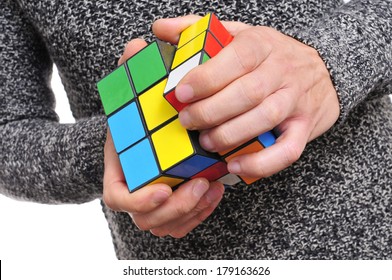 TARRAGONA, SPAIN - FEBRUARY 3, 2014: A Man Trying To Solve A Rubiks Cube. This Famous Cube Puzzle Was Invented By The Architect Erno Rubik In 1974