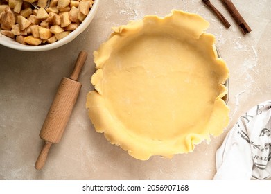 Tart dough or shortcrust pastry, in ceramic tart pan. Baking an apple rustic pie.