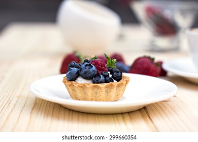 Tart  with Fresh berries - dessert on wooden table close up - Shutterstock ID 299660354