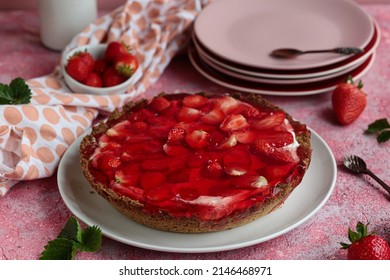 Tart with jelly and strawberries. Delicious tart with fruit and cream.