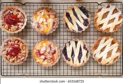 Tart Top View. From Left To Right : Strawberry Crumble Tarts, Peach Raspberry Almond Tarts, Blueberry Tarts, Apple Rhubarb Tarts