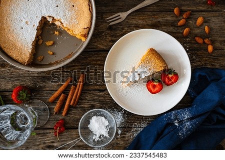 Tarta de Santiago - Spanish almond cake on wooden background