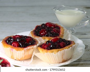 Tartlet Cake, With Raspberry And Strawberry Jam. Confectionery On A White Plate For A Children's Holiday. Liquid Cream In A Coffee Creamer.