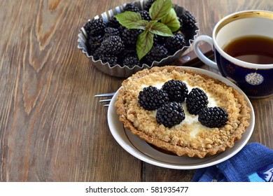 Tartlets with cream and blackberries, copy space