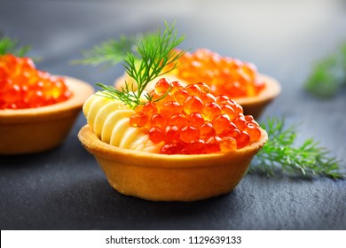 Tartlets with red caviar close up. Gourmet food close up, appetizer. Close-up salmon caviar. Delicatessen. Gourmet food. Texture of caviar. Seafood.