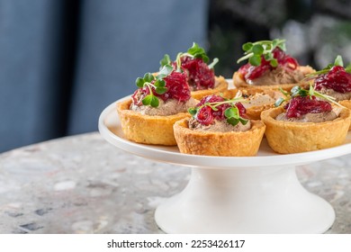 Tartlets stuffed with codfish liver, codfish caviar and microgreens. Traditional cold portioned appetizer in a pastry basket. - Shutterstock ID 2253426117