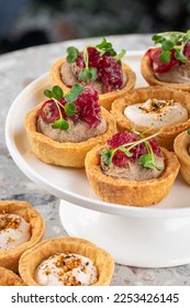 Tartlets stuffed with codfish liver, codfish caviar and microgreens. Traditional cold portioned appetizer in a pastry basket. - Shutterstock ID 2253426145
