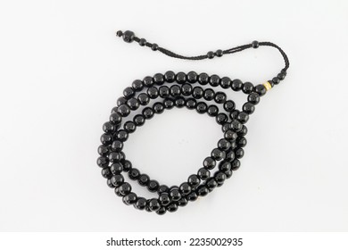 tasbih is a tool or infrastructure for dhikr. is glorifying dhikr. remember god. wooden prayer beads. plain white background. - Shutterstock ID 2235002935
