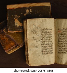 Tashkent, Uzbekistan - August 10, 2009: Stack Of Open Ancient Books In Arabic. Old Arabic Manuscripts And Texts. Top View