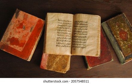 Tashkent, Uzbekistan - August 10, 2009: Stack Of Open Ancient Books In Arabic. Old Arabic Manuscripts And Texts. Top View