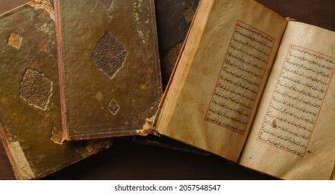 Tashkent, Uzbekistan - August 10, 2009: Stack Of Open Ancient Books In Arabic. Old Arabic Manuscripts And Texts. Top View