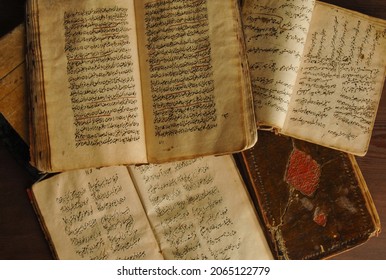 Tashkent, Uzbekistan - August 10, 2009: Stack Of Open Ancient Books In Arabic. Old Arabic Manuscripts And Texts. Top View