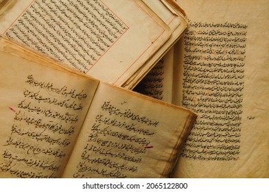 Tashkent, Uzbekistan - August 10, 2009: Stack of open ancient books in Arabic. Old Arabic manuscripts and texts. Top view