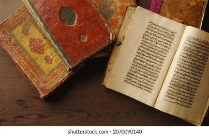 Tashkent, Uzbekistan - August 10, 2009: Stack Of Open Ancient Books In Arabic. Old Arabic Manuscripts And Texts. Top View