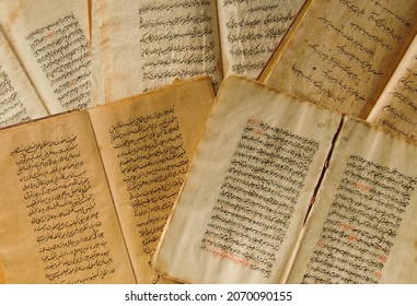 Tashkent, Uzbekistan - August 10, 2009: Stack Of Open Ancient Books In Arabic. Old Arabic Manuscripts And Texts. Top View