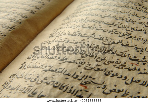 Tashkent, Uzbekistan -\
August 10, 2009: Ancient open book in arabic. Old arabic\
manuscripts and texts