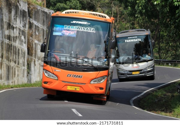 Tasikmalaya, West Java,\
Indonesia - September 23, 2017 : The tour bus turns on the Gentong\
Tasikmalaya\
street.