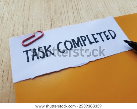 Task completed writting on table background.