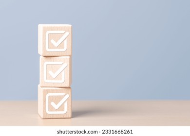 Task lists, Checklist, Survey, Assessment, List, Planner, Confirmation, Double check. Quality Control. Goals achievement and business success. Check mark for jobs list icons on wooden stacked blocks. - Shutterstock ID 2331668261