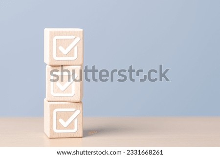 Task lists, Checklist, Survey, Assessment, List, Planner, Confirmation, Double check. Quality Control. Goals achievement and business success. Check mark for jobs list icons on wooden stacked blocks.