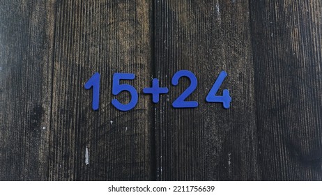 Task In Mathematics. Mathematics Problem For Children. Simple Algebra Examples Using Numbers And Signs From Plastic Numbers On A Wooden Background.