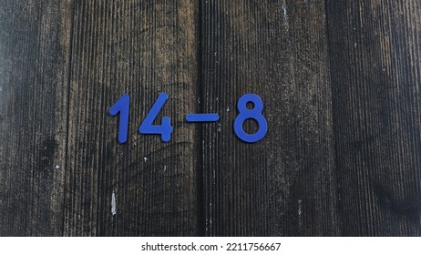 Task In Mathematics. Mathematics Problem For Children. Simple Algebra Examples Using Numbers And Signs From Plastic Numbers On A Wooden Background.