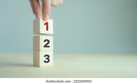 Task priority and management concept. The order of priority in any activity. Set work priority, arrange to do list. Wooden cubes with number first, second and third.