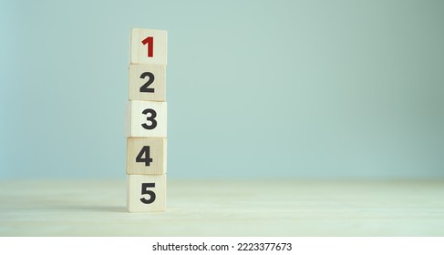 Task priority and management concept. The order of priority in any activity. Set work priority, arrange to do list. Wooden cubes with number first, second, third, fourth and fifth.