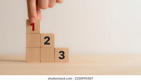 Task priority and management concept. The order of priority in any activity. Set work priority, arrange to do list. Wooden cube blocks with number first, second and third.