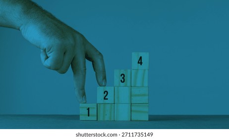 Task priority and management concept. The order of priority in any activity. Set work priority, arrange to do list. Wooden cubes with number first, second and third