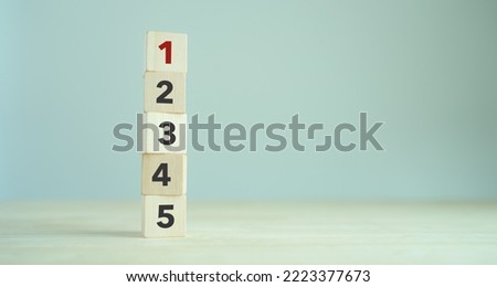 Task priority and management concept. The order of priority in any activity. Set work priority, arrange to do list. Wooden cubes with number first, second, third, fourth and fifth.