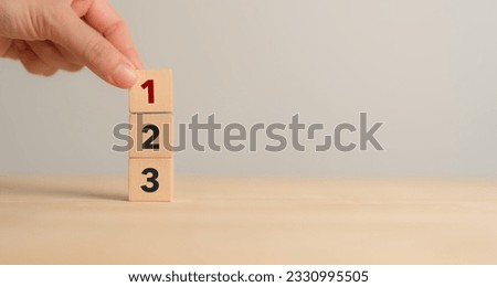 Task priority and management concept. The order of priority in any activity. Set work priority, arrange to do list. Wooden cube blocks with number first, second and third.