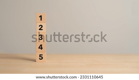 Task priority and management concept. The order of priority in any activity. Set work priority, arrange to do list. Wooden cube blocks with number first, second, third, fourth and fifth.