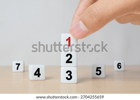 Task priority and management concept, The order of priority in any activity, Set work priority, arrange to do list. Hand arranging dice with number first, second, third, four, five, six, seven.