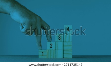 Task priority and management concept. The order of priority in any activity. Set work priority, arrange to do list. Wooden cubes with number first, second and third