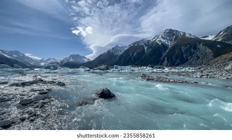 The Tasman river rushing out of  the alpine lake leaving behind lots of icebergs on the surface of the lake - Powered by Shutterstock