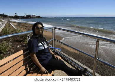 Tasmania, Australia - 01.30.2022 Lady sitting and enjoying at penguin beach, Penguin, Tasmania, Australia - Powered by Shutterstock