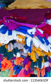 tasseled fabrics on market stall in sanliurfa, turkey