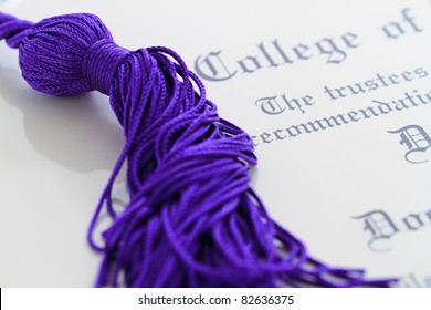 Tassel/honor Cords Resting On Top Of Graduation Paperwork