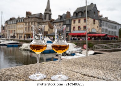 Tasting Of Apple Calvados Drink From Glasses In Old Honfleur Harbour With Boats And Old Houses On Background, Normandy, France