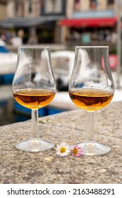 Tasting Of Apple Calvados Drink From Glasses In Old Honfleur Harbour With Boats And Old Houses On Background, Normandy, France