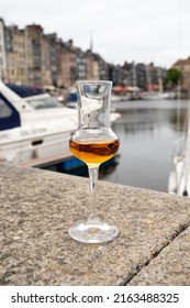 Tasting Of Apple Calvados Drink From Glasses In Old Honfleur Harbour With Boats And Old Houses On Background, Normandy, France