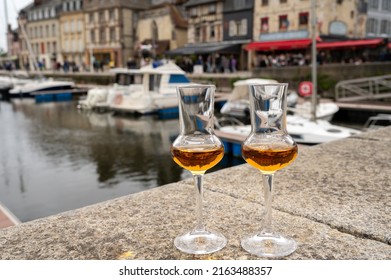 Tasting Of Apple Calvados Drink From Glasses In Old Honfleur Harbour With Boats And Old Houses On Background, Normandy, France