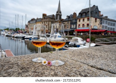 Tasting Of Apple Calvados Drink From Glasses In Old Honfleur Harbour With Boats And Old Houses On Background, Normandy, France